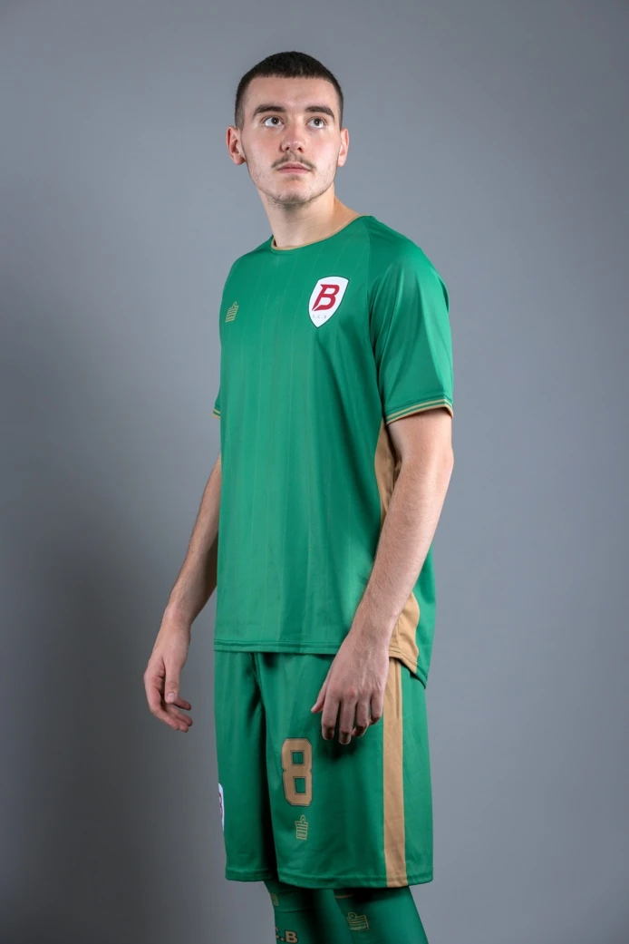 SC Brooklyn player wearing the Kelly green away kit with gold side panels